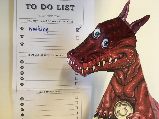 A paper dragon next to a to-do list, with "nothing" checked as the only thing on the list